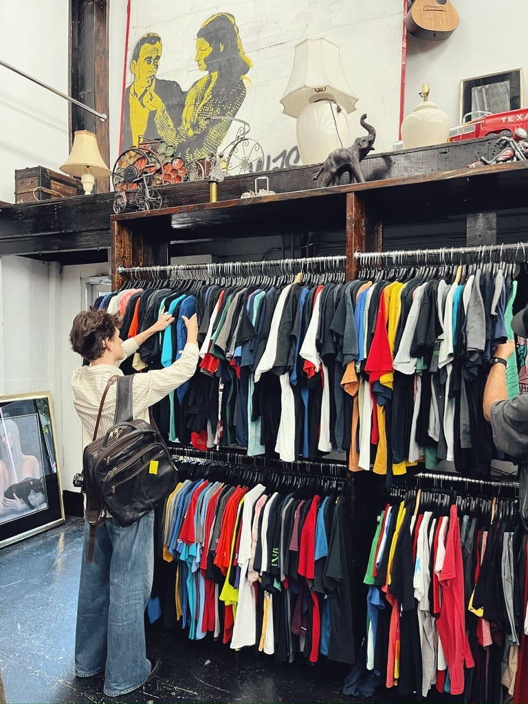 Person looking for T-shirt at L Train Vintage in Bushwick, Brooklyn